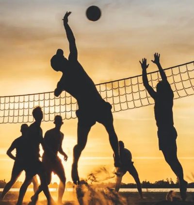 People play volleyball on the beach